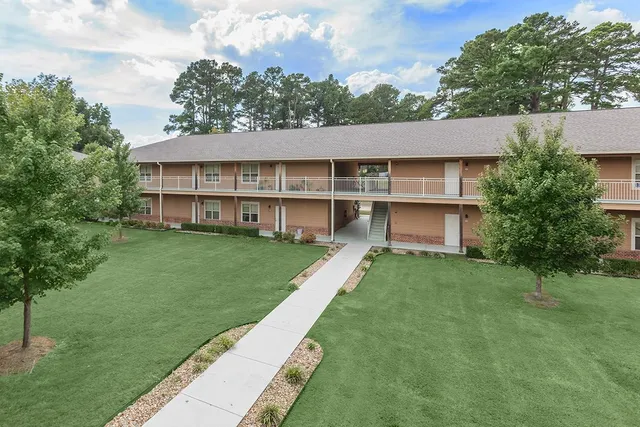 a view of a house with a backyard