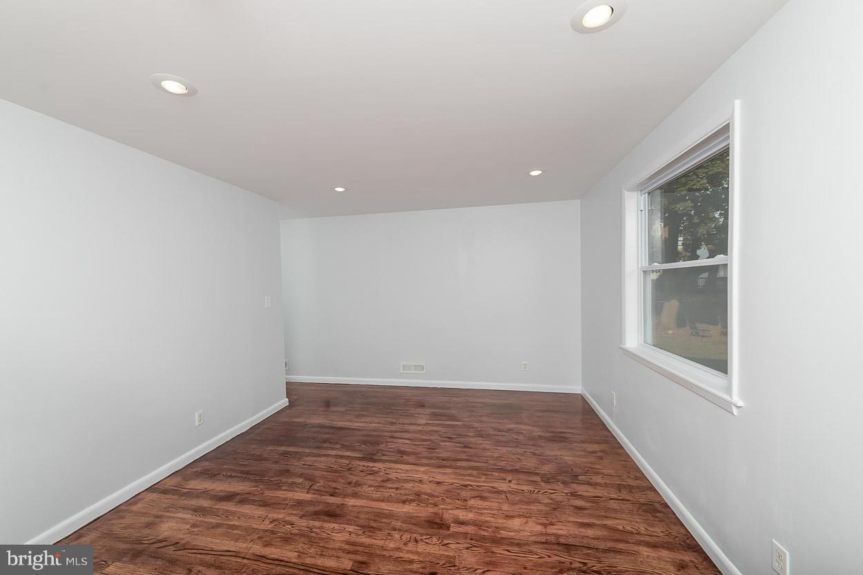 9120 Bengal Road Randallstown, MD 21133 - Photo 12 of 30 an empty room with wooden floor and windows