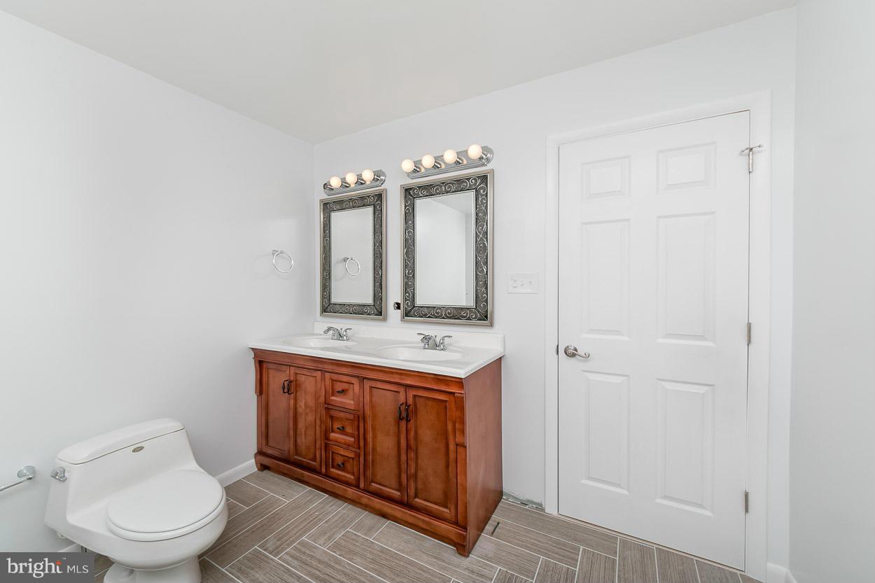 9120 Bengal Road Randallstown, MD 21133 - Photo 15 of 30 a bathroom with a toilet a sink and mirror
