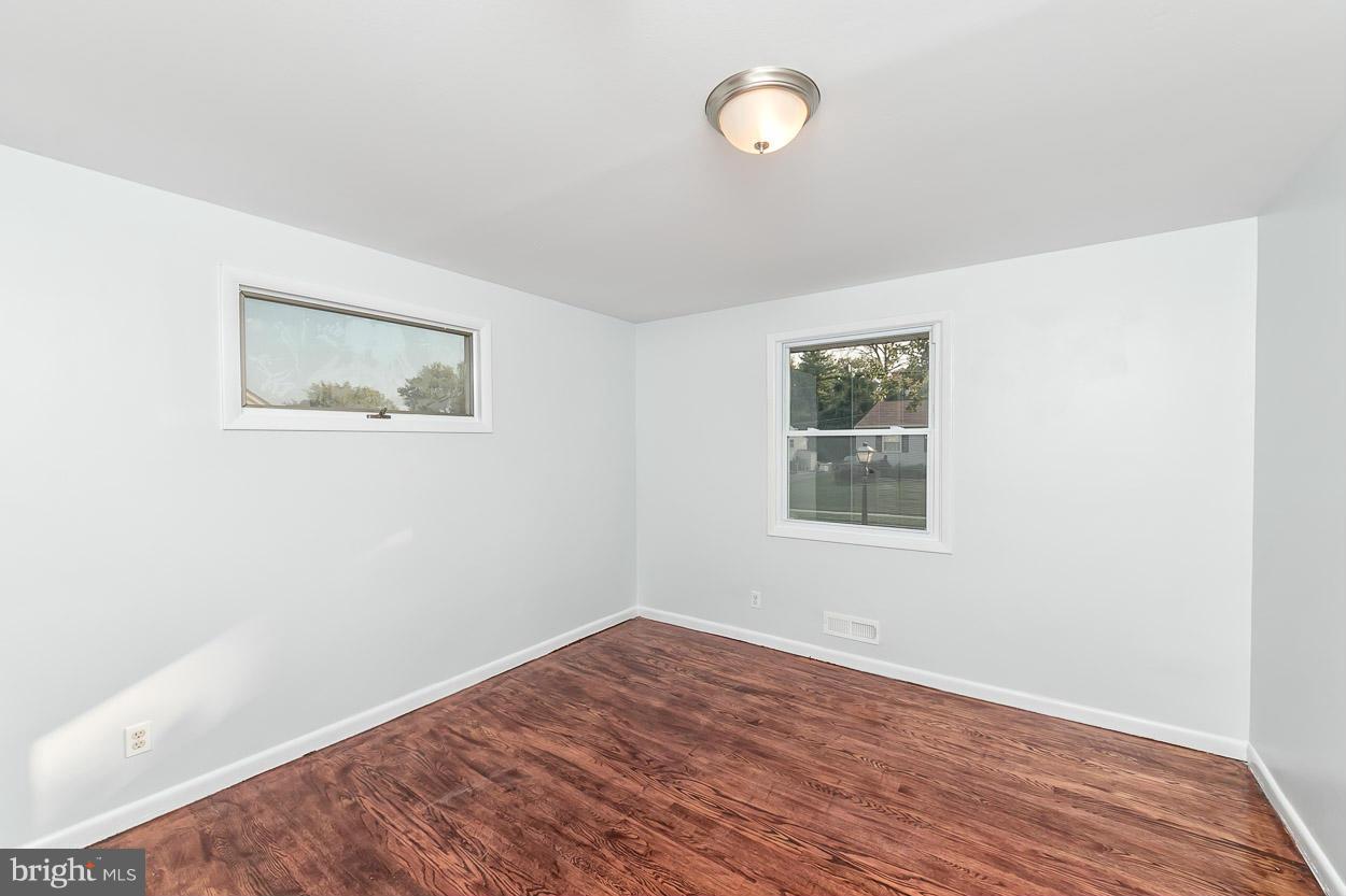 9120 Bengal Road Randallstown, MD 21133 - Photo 16 of 30 a view of an empty room with wooden floor and a window