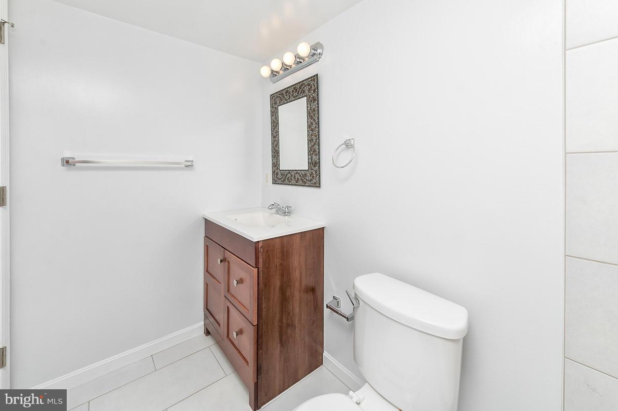 9120 Bengal Road Randallstown, MD 21133 - Photo 28 of 30 a bathroom with a toilet a sink a vanity and mirror