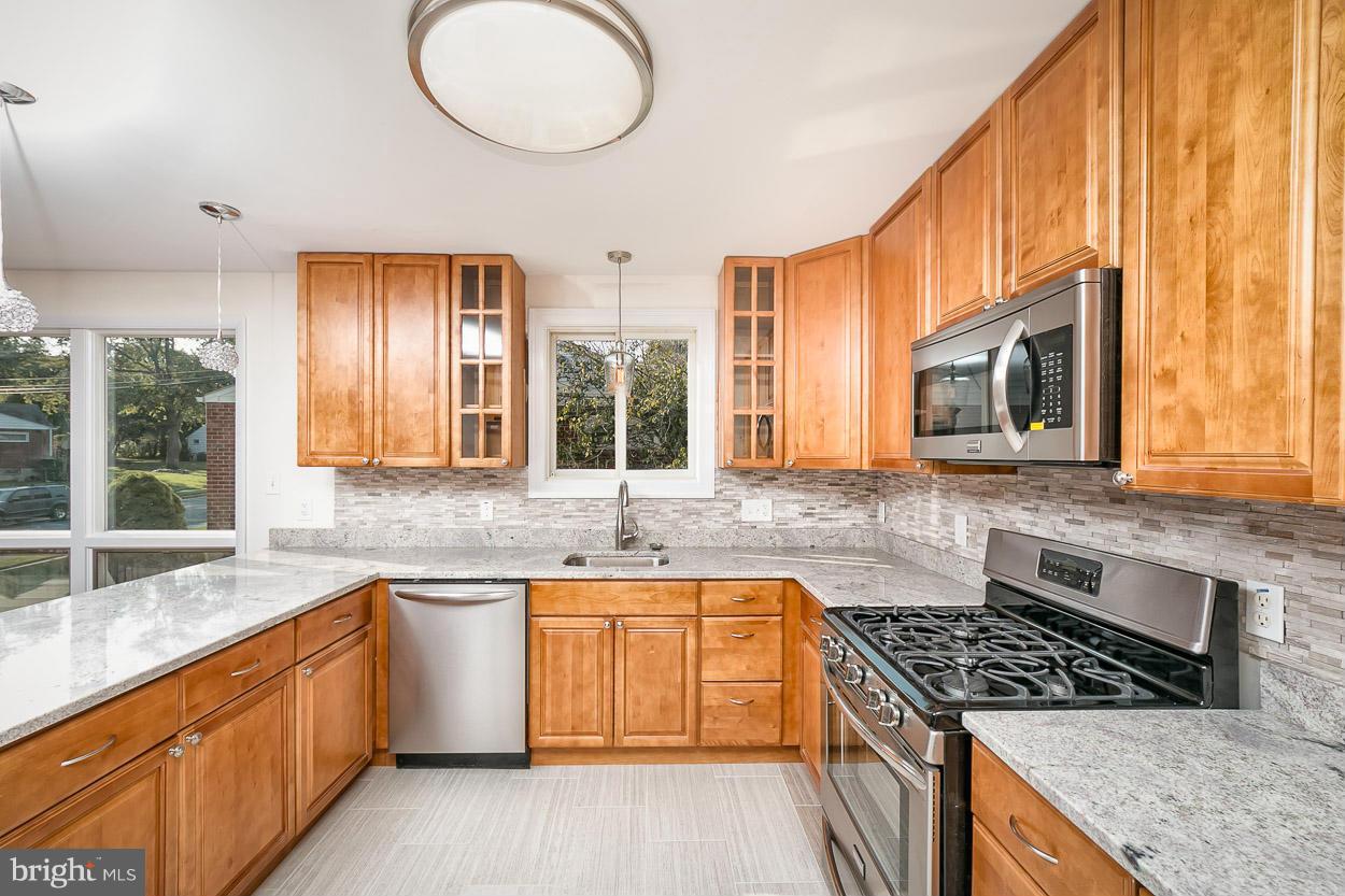 9120 Bengal Road Randallstown, MD 21133 - Photo 29 of 30 a kitchen with stainless steel appliances granite countertop a stove a sink and a microwave