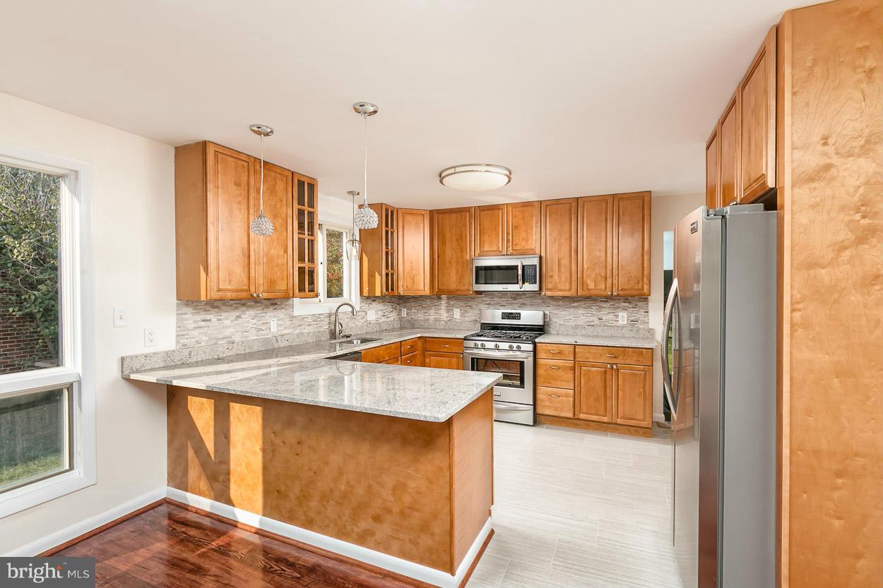 9120 Bengal Road Randallstown, MD 21133 - Photo 5 of 30 a kitchen with stainless steel appliances granite countertop a sink stove and refrigerator