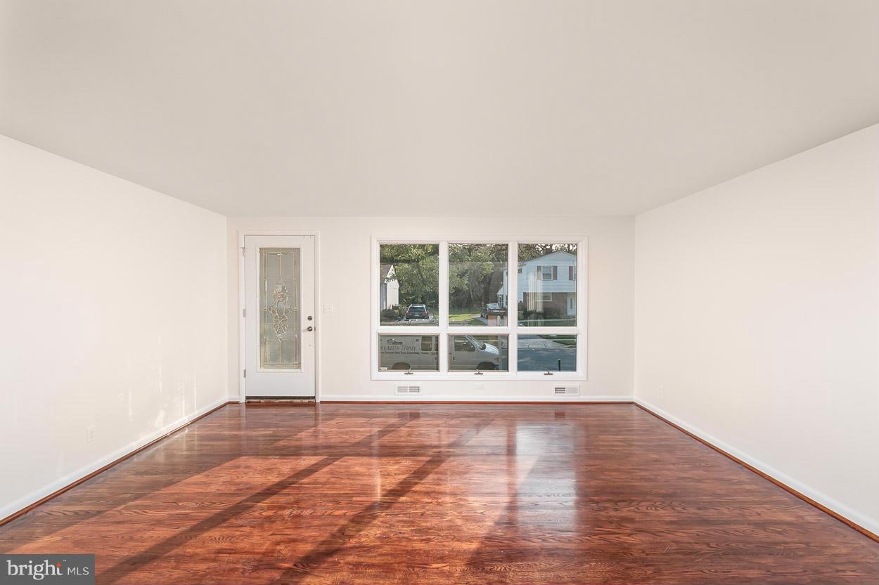 9120 Bengal Road Randallstown, MD 21133 - Photo 8 of 30 an empty room with wooden floor and windows