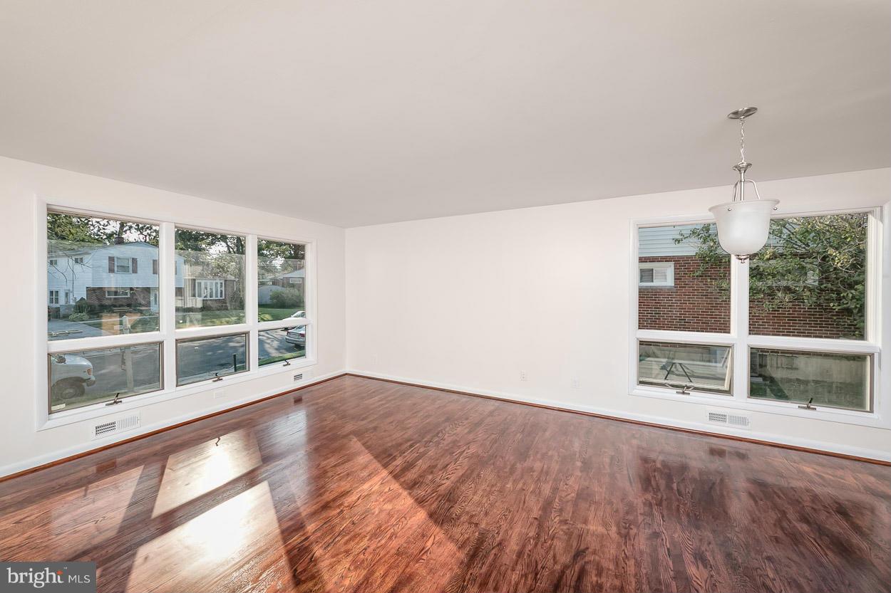 9120 Bengal Road Randallstown, MD 21133 - Photo 9 of 30 an empty room with wooden floor and windows