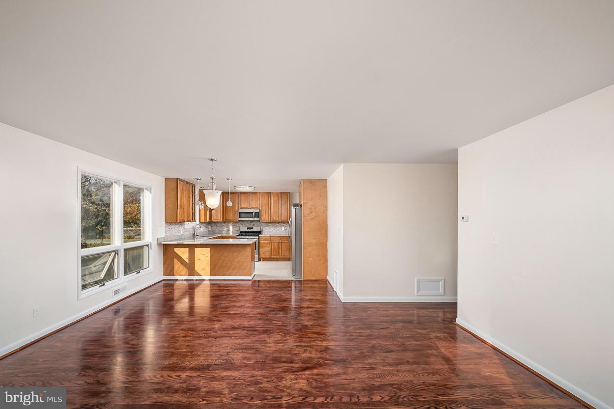 9120 Bengal Road Randallstown, MD 21133 - Photo 10 of 30 a view of empty room with wooden floor and floor to ceiling window