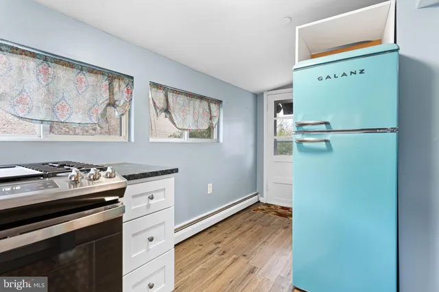 a kitchen with a refrigerator and a stove