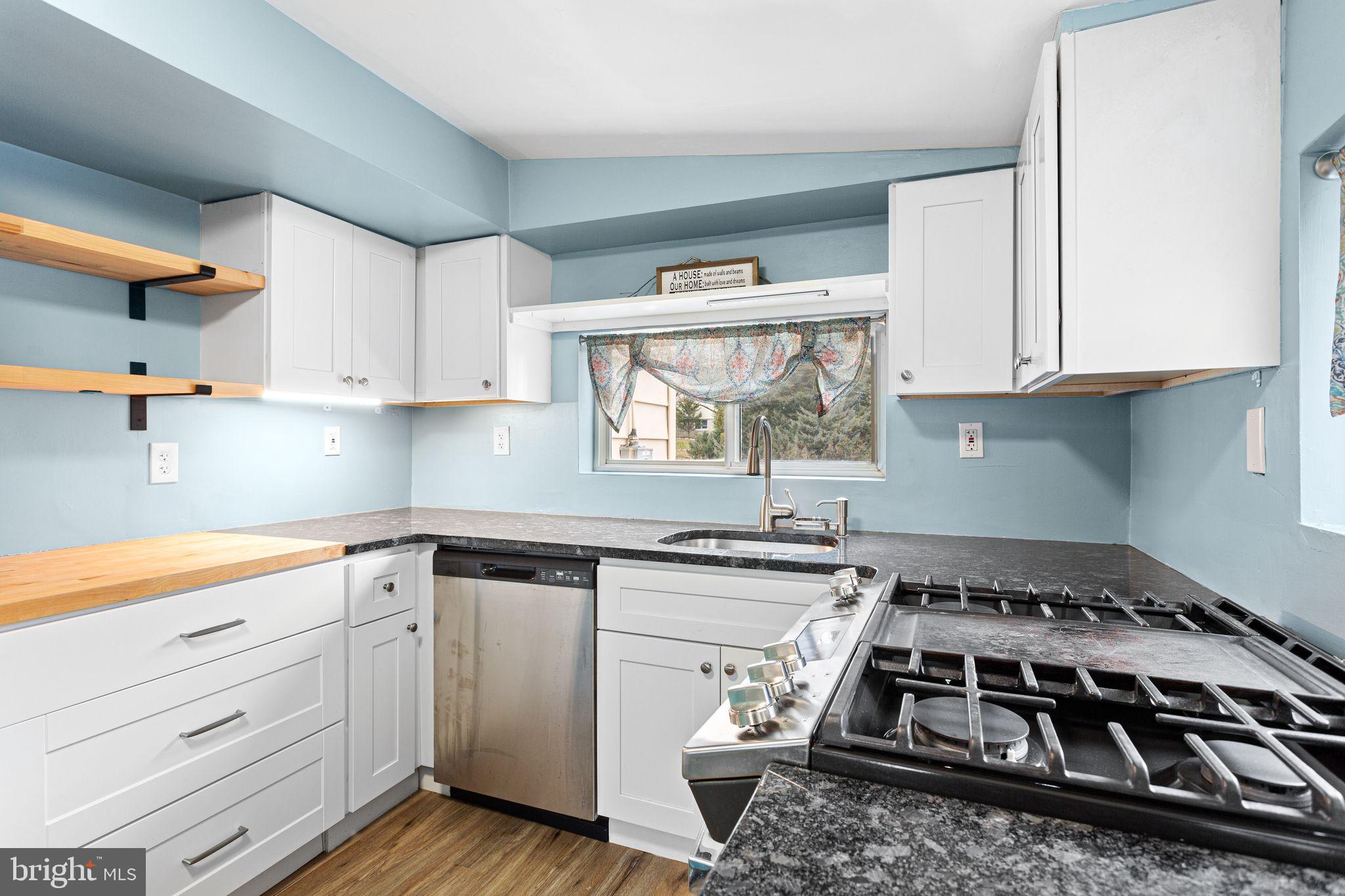 224 South Pennell Road Media, PA 19063 - Photo 10 of 27 a kitchen with a stove and white cabinets
