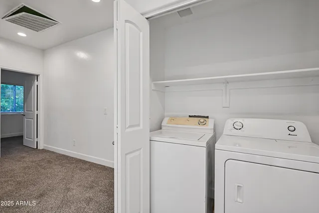 a view of storage and utility room with washer and dryer