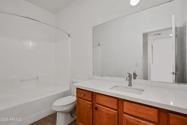 a bathroom with a sink toilet a mirror and shower