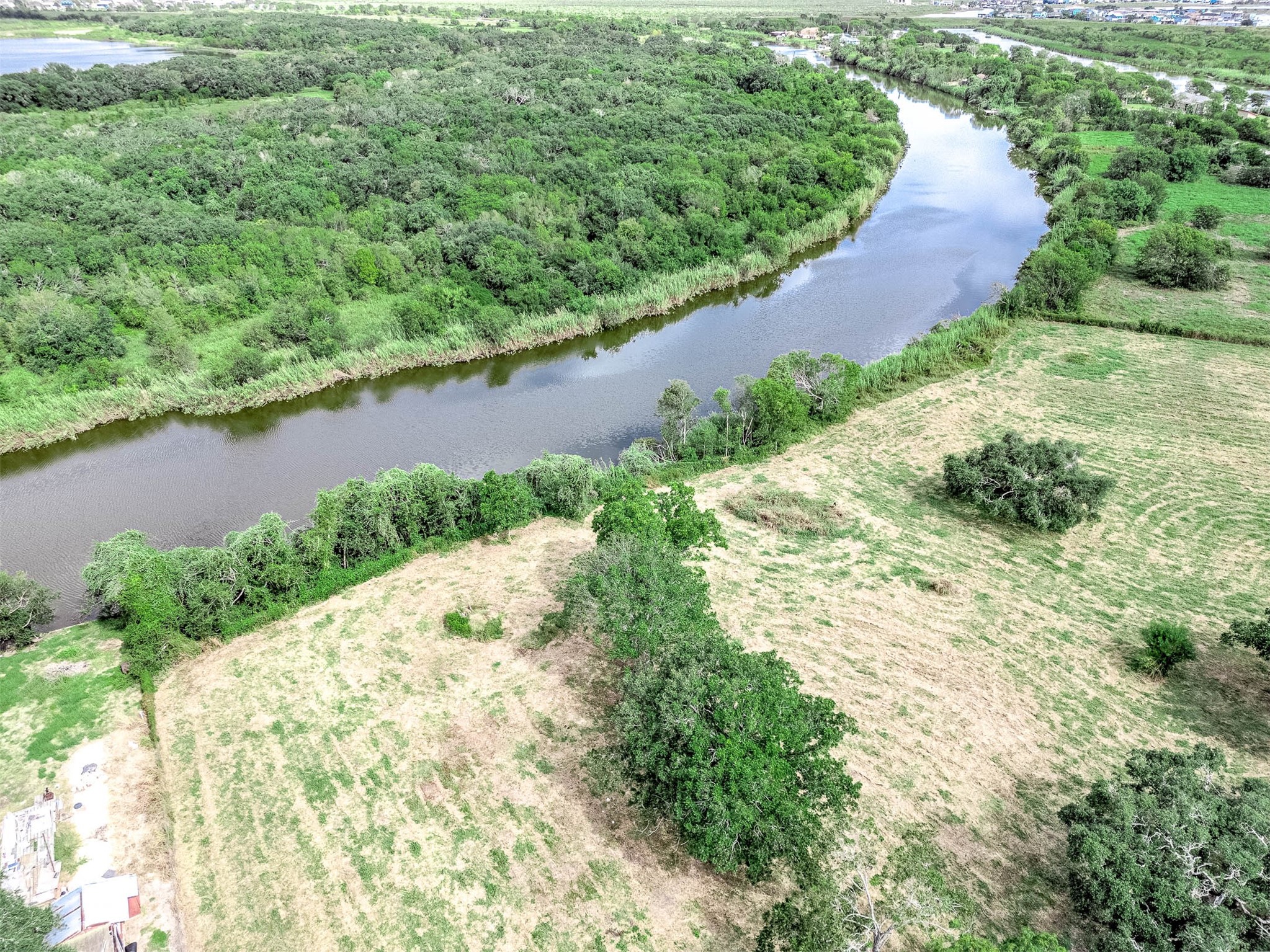 2230 Duncan Drive Freeport, TX 77541 - Photo 10 of 12 an aerial view of a house with a yard and lake view