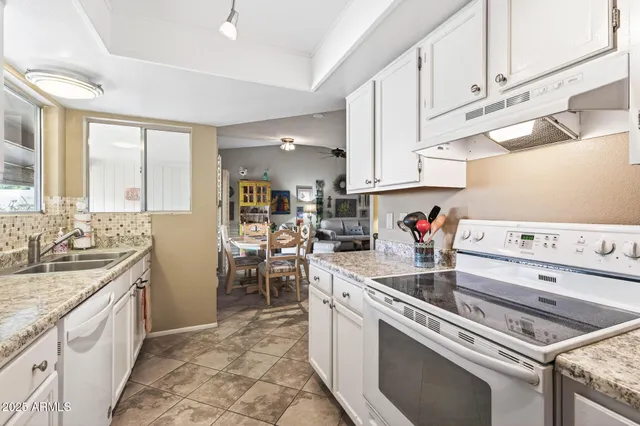 a kitchen that has a lot of cabinets in it and appliances
