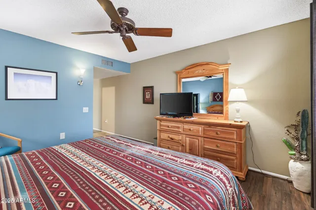 a bedroom with a bed and a flat screen tv