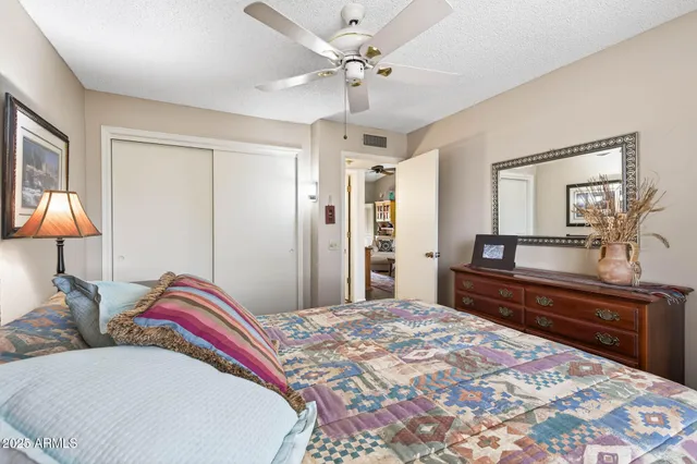 a bedroom with a bed and a lamp