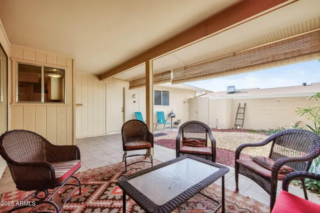 a living room with furniture a rug and a window