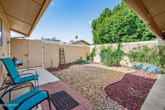 a view of a backyard with furniture