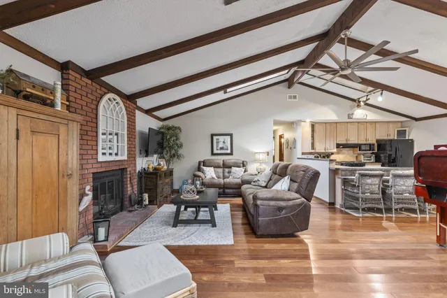 a living room with furniture or fireplace and a table