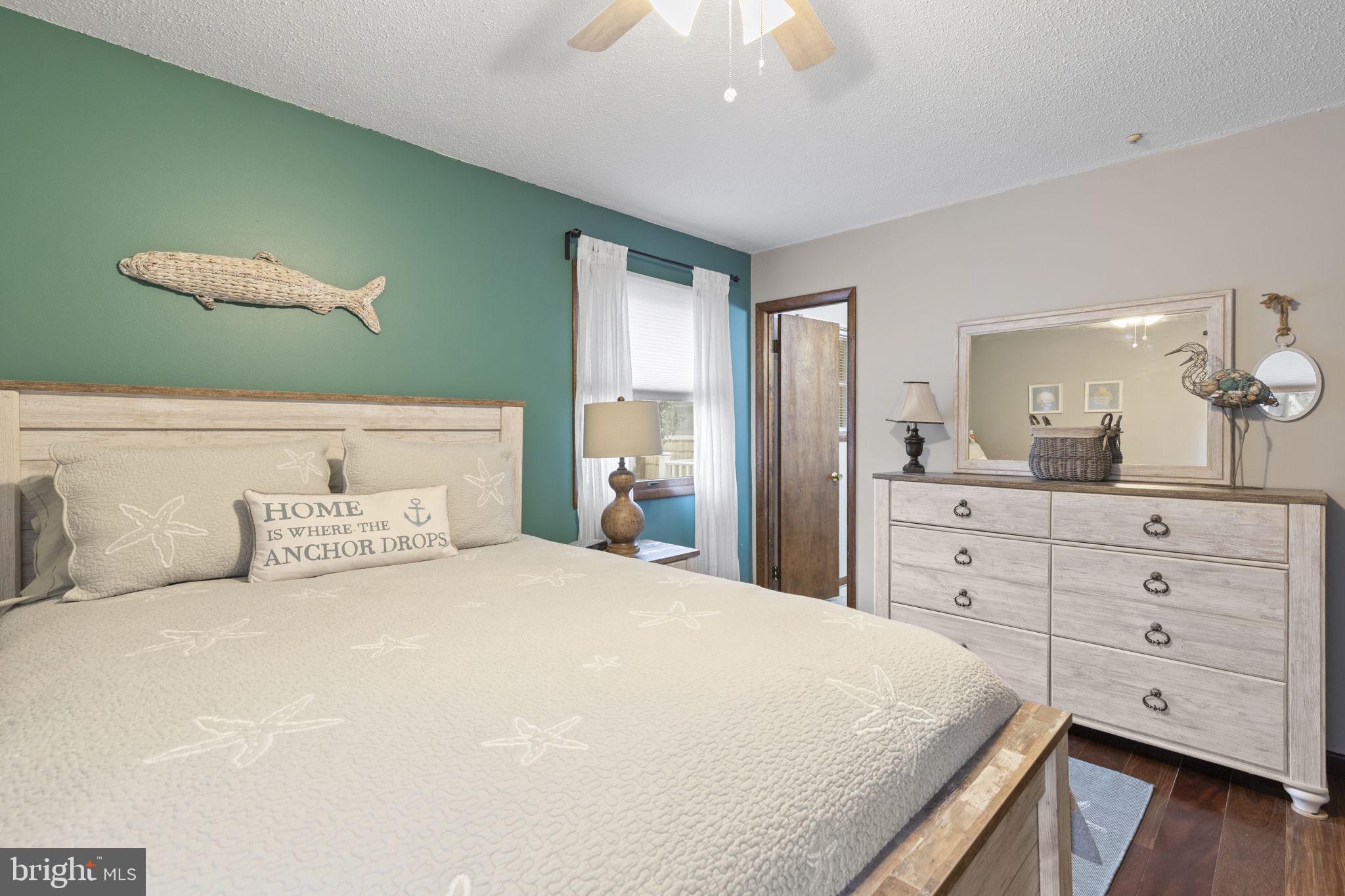 48 Battersea Road Ocean Pines, MD 21811 - Photo 19 of 46 a bedroom with a large bed and a dresser