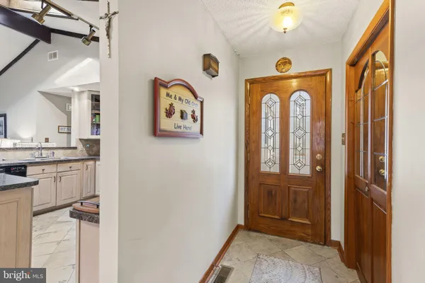 a view of front door with hallway and door