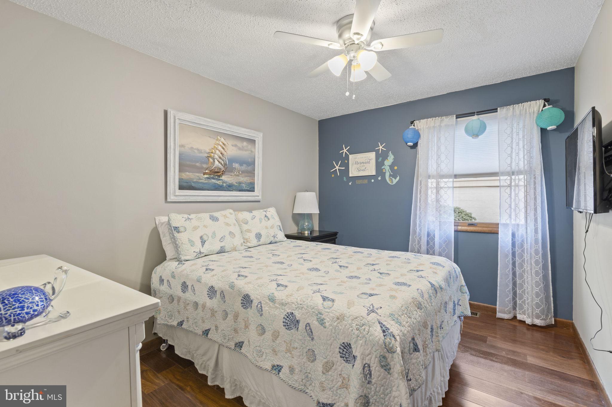 48 Battersea Road Ocean Pines, MD 21811 - Photo 21 of 46 a bedroom with a bed and a chandelier