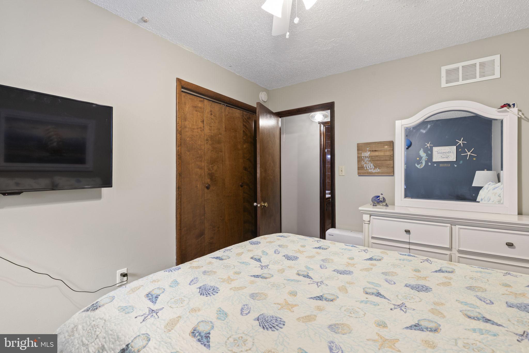 48 Battersea Road Ocean Pines, MD 21811 - Photo 22 of 46 a bedroom with a bed and a flat screen tv