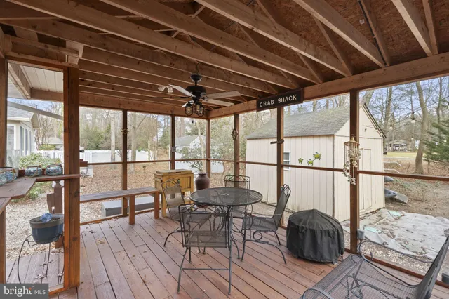 a view of a dining room with furniture large windows and wooden floor