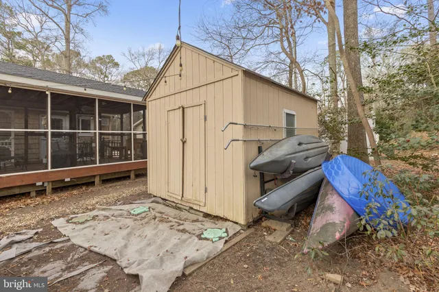 a backyard of a house with barbeque oven table and chairs