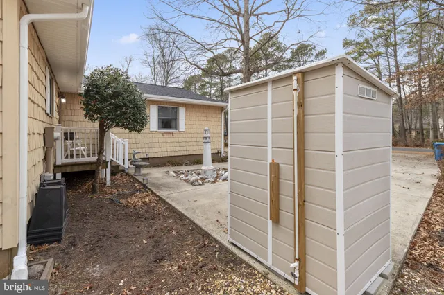 a view of a house with a patio and a yard