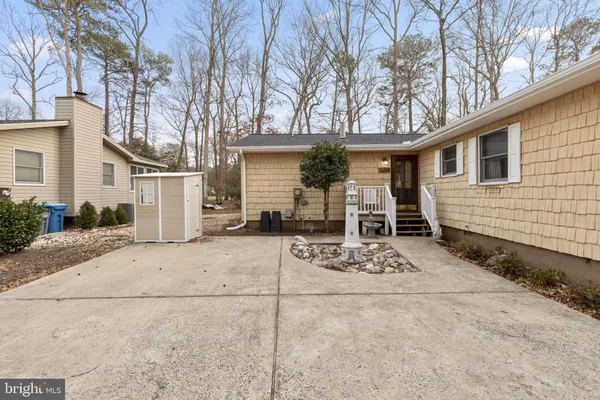 a front view of a house with outdoor seating