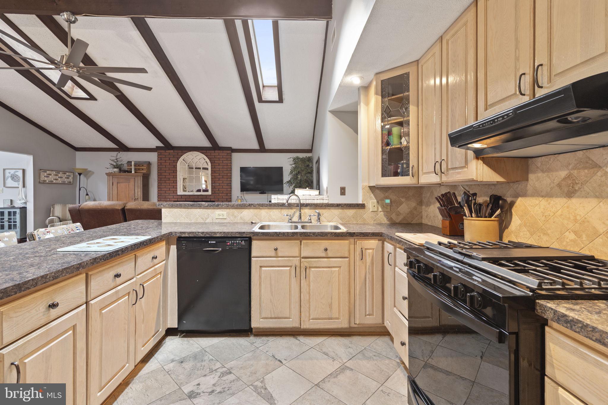 48 Battersea Road Ocean Pines, MD 21811 - Photo 5 of 46 a kitchen with granite countertop a sink stove and cabinets