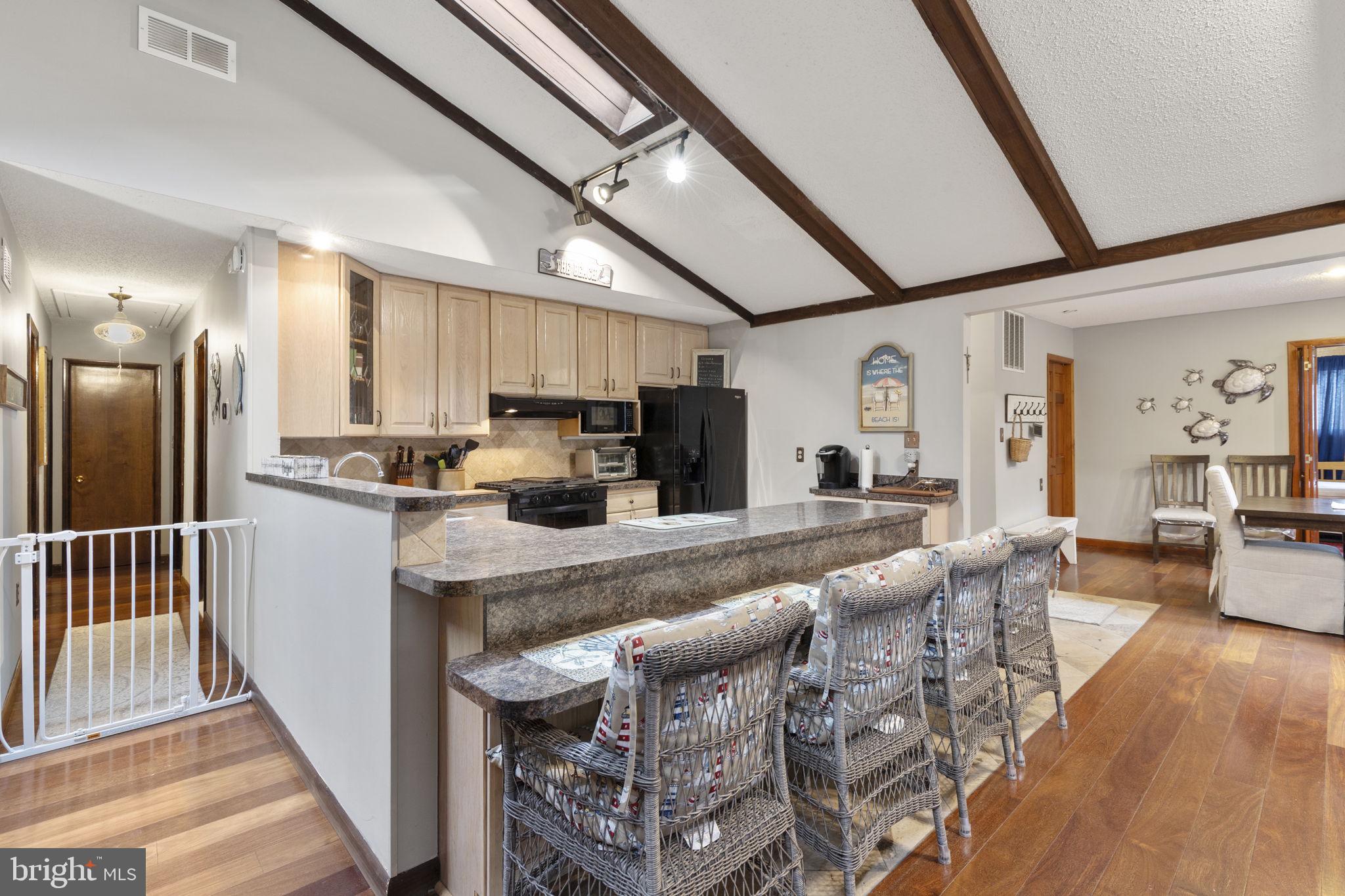48 Battersea Road Ocean Pines, MD 21811 - Photo 6 of 46 a large white kitchen with lots of counter space and stainless steel appliances