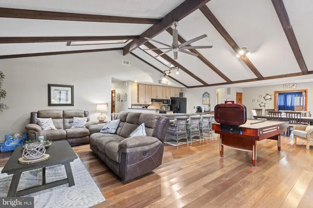 a living room with furniture and wooden floors