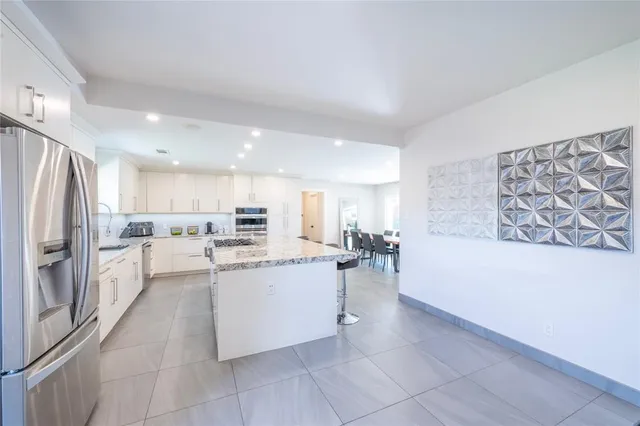 a kitchen with stainless steel appliances a refrigerator and a stove top oven
