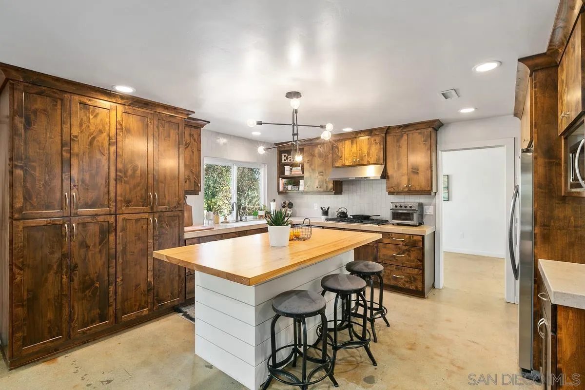 2815 Jacaranda Avenue Carlsbad, CA 92009 - Photo 13 of 30 a large kitchen with a table and chairs