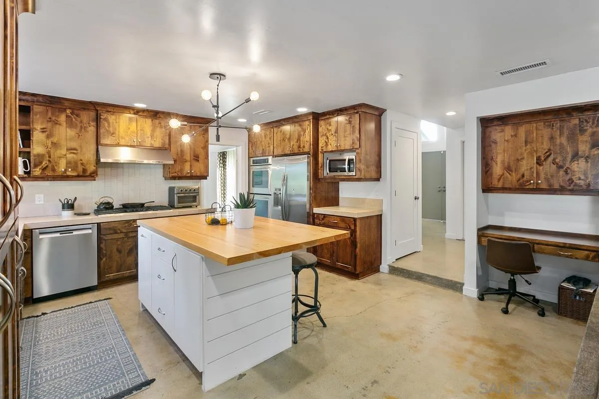 2815 Jacaranda Avenue Carlsbad, CA 92009 - Photo 15 of 30 a kitchen with a stove a refrigerator and a stove top oven