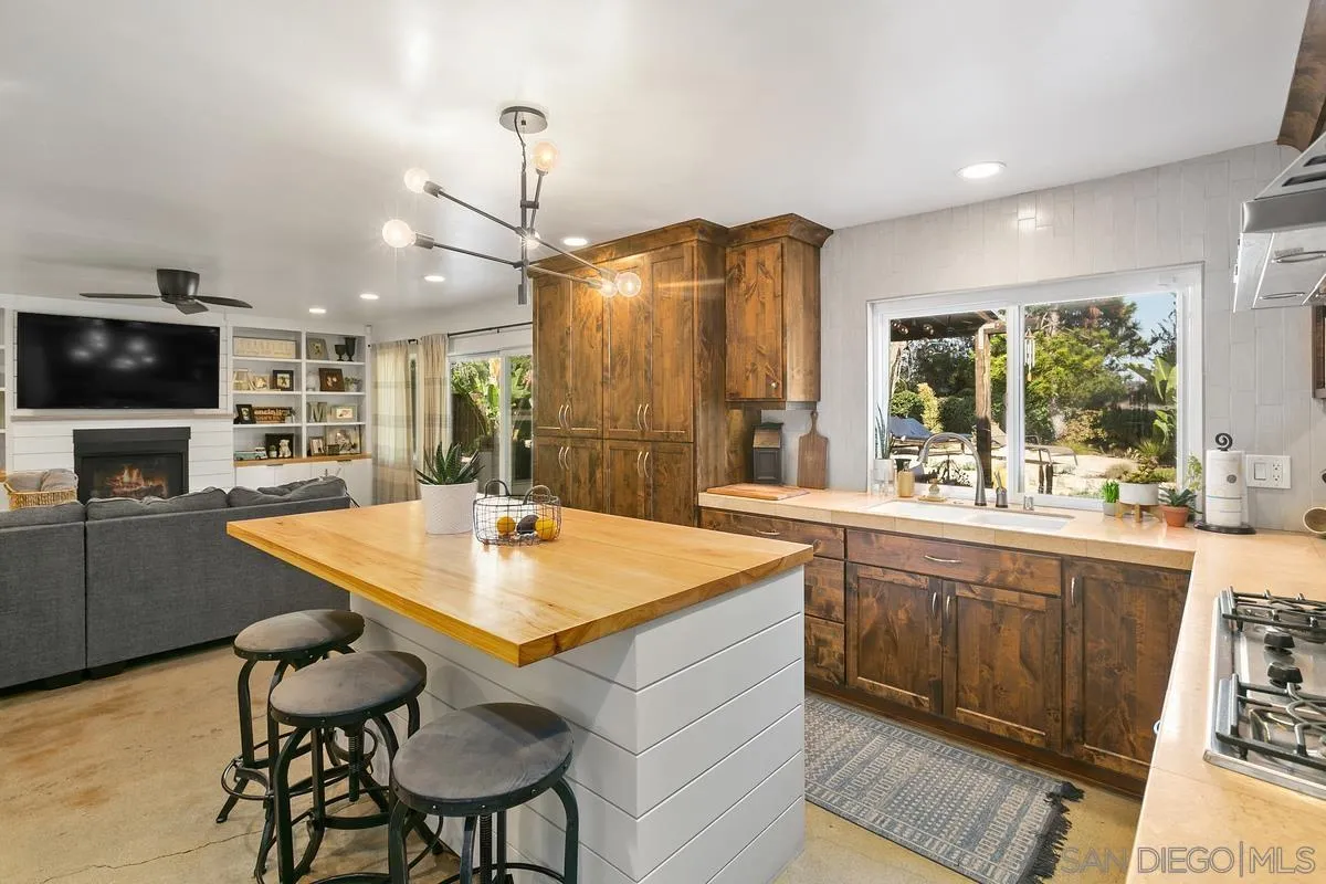 2815 Jacaranda Avenue Carlsbad, CA 92009 - Photo 16 of 30 a kitchen with a table chairs sink and wooden floor
