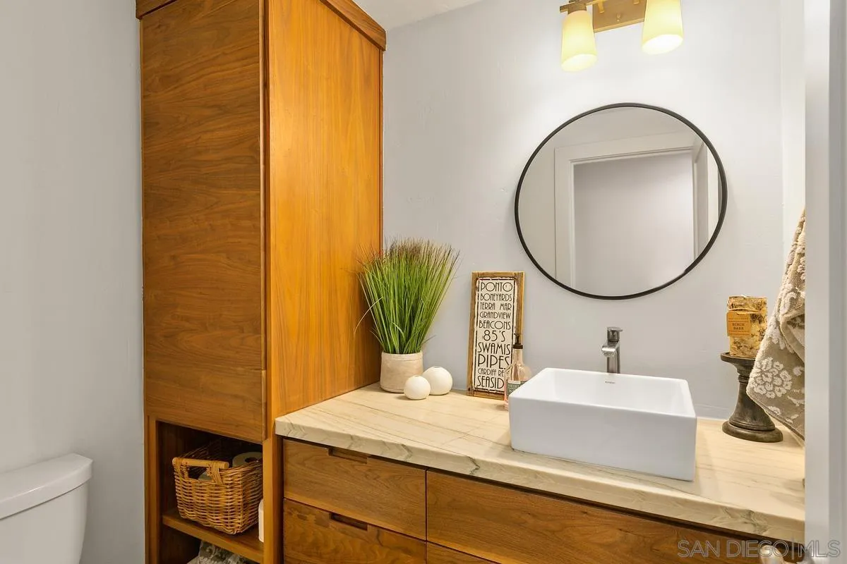 2815 Jacaranda Avenue Carlsbad, CA 92009 - Photo 17 of 30 a bathroom with a sink and a mirror