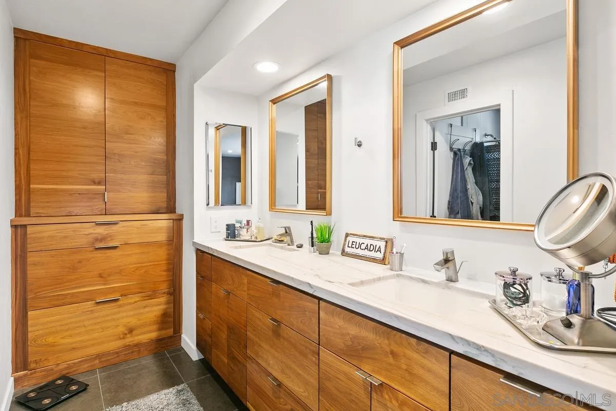 2815 Jacaranda Avenue Carlsbad, CA 92009 - Photo 21 of 30 a bathroom with a double vanity sink and a mirror