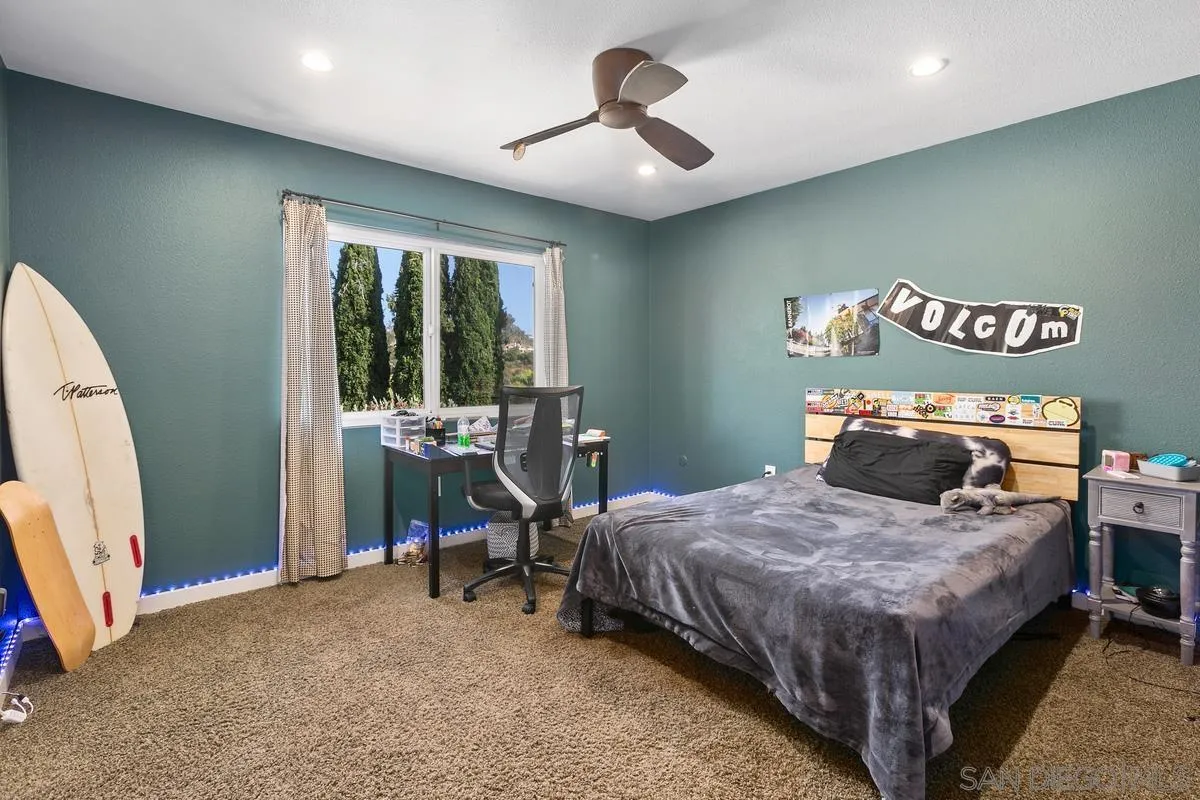 2815 Jacaranda Avenue Carlsbad, CA 92009 - Photo 23 of 30 a bedroom with a bed and a chandelier