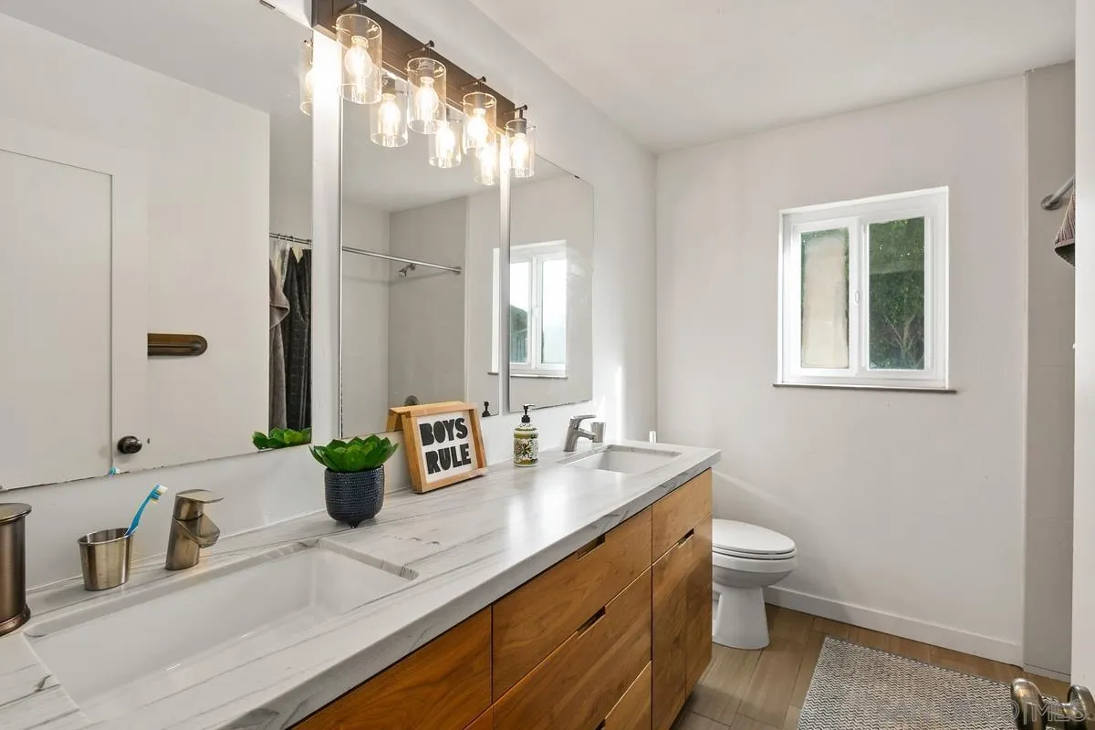 2815 Jacaranda Avenue Carlsbad, CA 92009 - Photo 24 of 30 a bathroom with double vanity sinks and a mirror