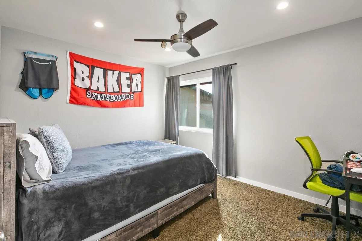 2815 Jacaranda Avenue Carlsbad, CA 92009 - Photo 25 of 30 a bedroom with a bed and a chair