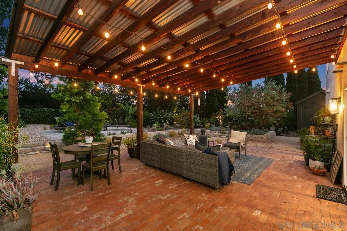 2815 Jacaranda Avenue Carlsbad, CA 92009 - Photo 3 of 30 a view of a patio with couches and table with chairs and potted plants