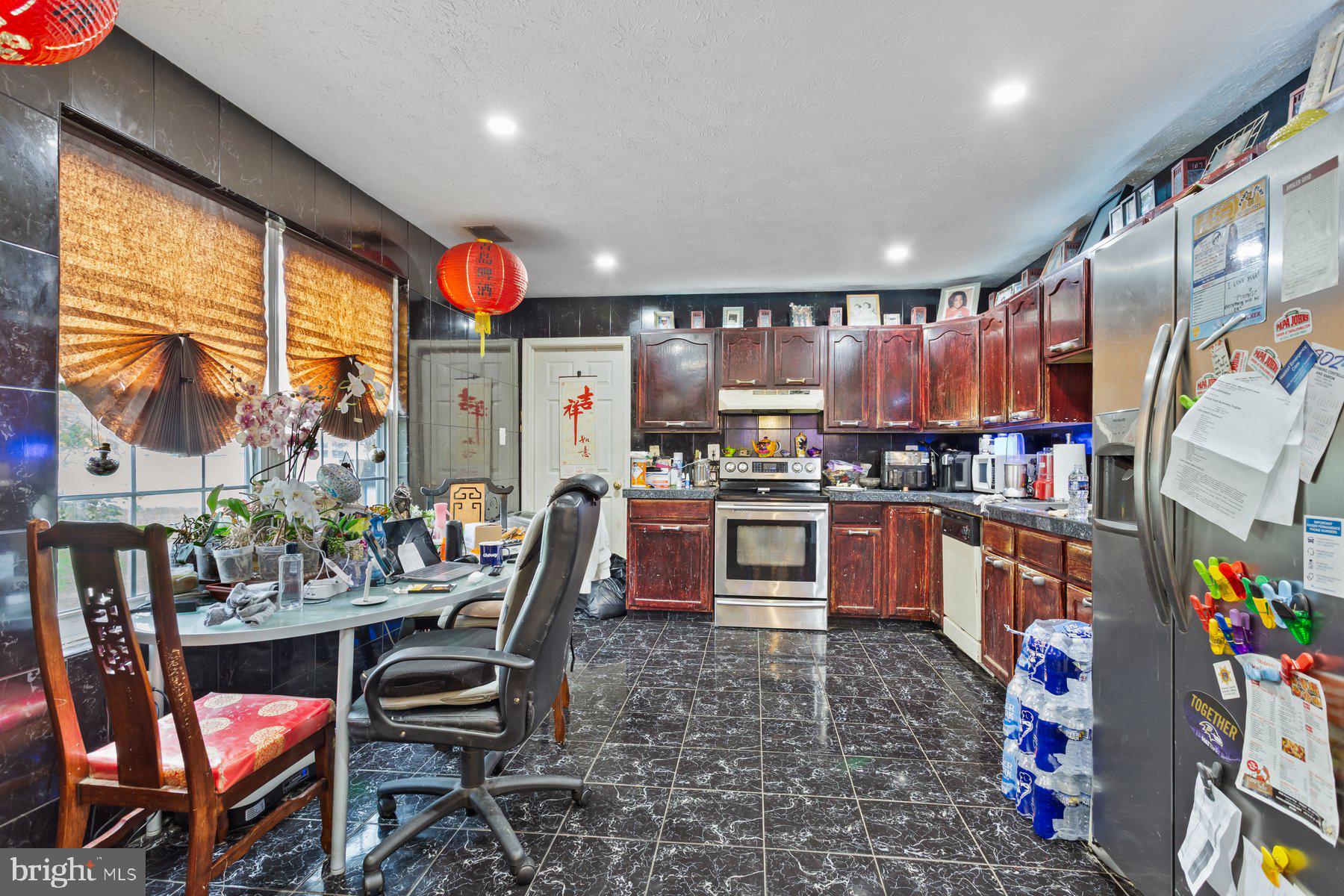 2448 Shellcove Court Waldorf, MD 20601 - Photo 15 of 38 a kitchen with stainless steel appliances kitchen island granite countertop a sink and cabinets