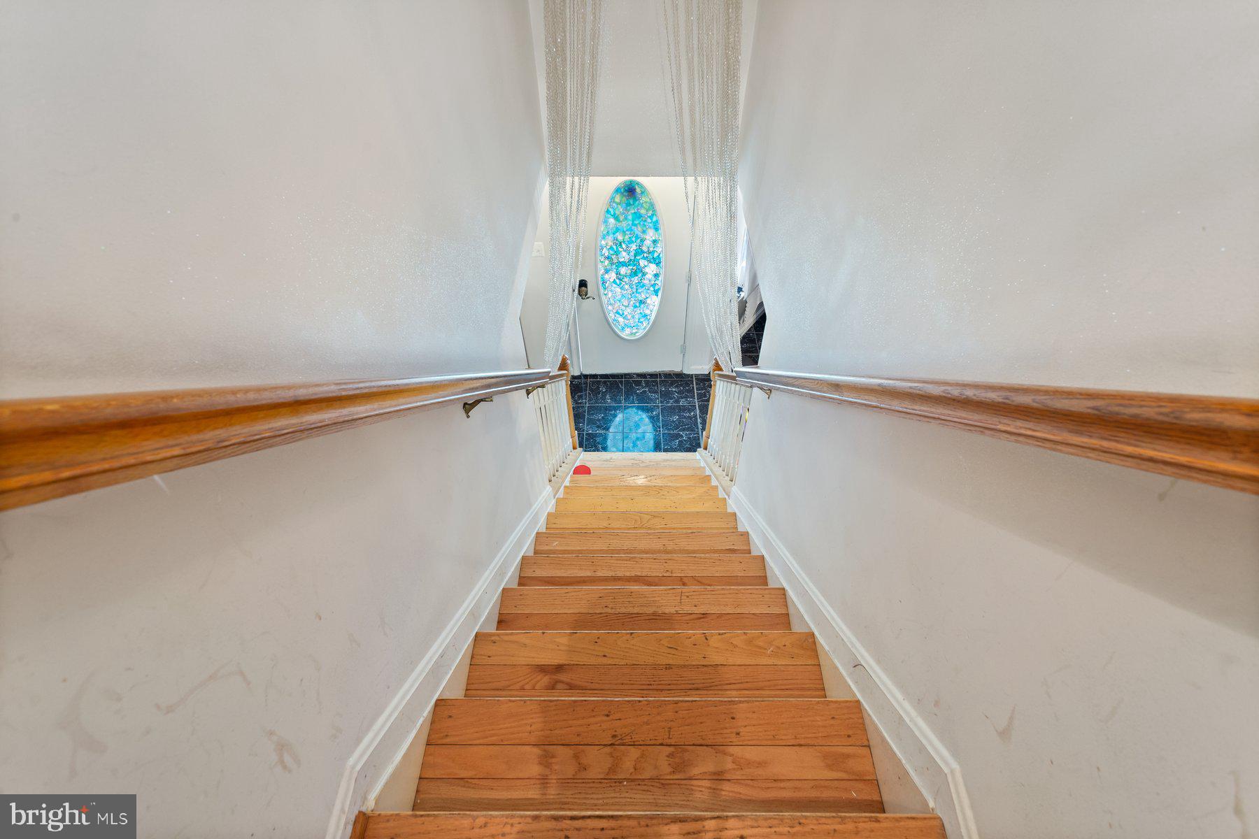 2448 Shellcove Court Waldorf, MD 20601 - Photo 26 of 38 a hallway with stairs and a white door