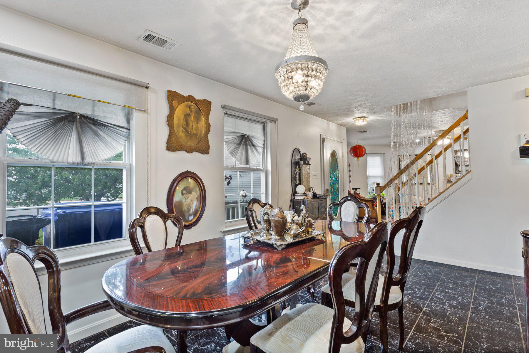 2448 Shellcove Court Waldorf, MD 20601 - Photo 3 of 38 a dining room with furniture a rug and a chandelier
