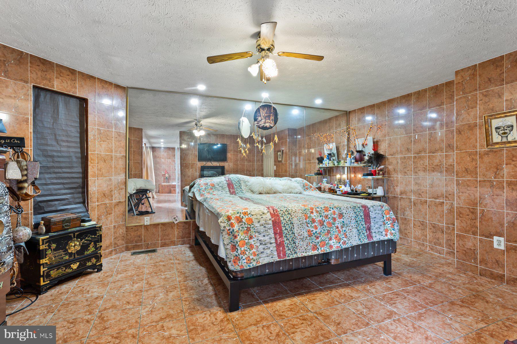 2448 Shellcove Court Waldorf, MD 20601 - Photo 31 of 38 a large bedroom with a bed and a chandelier