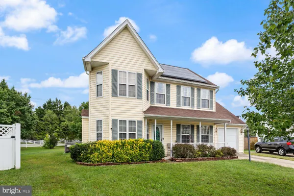 a view of a house with a yard and plants