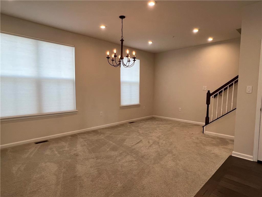 2356 Raya Way Easton, PA 18045 - Photo 8 of 28 Plush carpeting anchors this versatile living space featuring recessed lighting and a central chandelier.