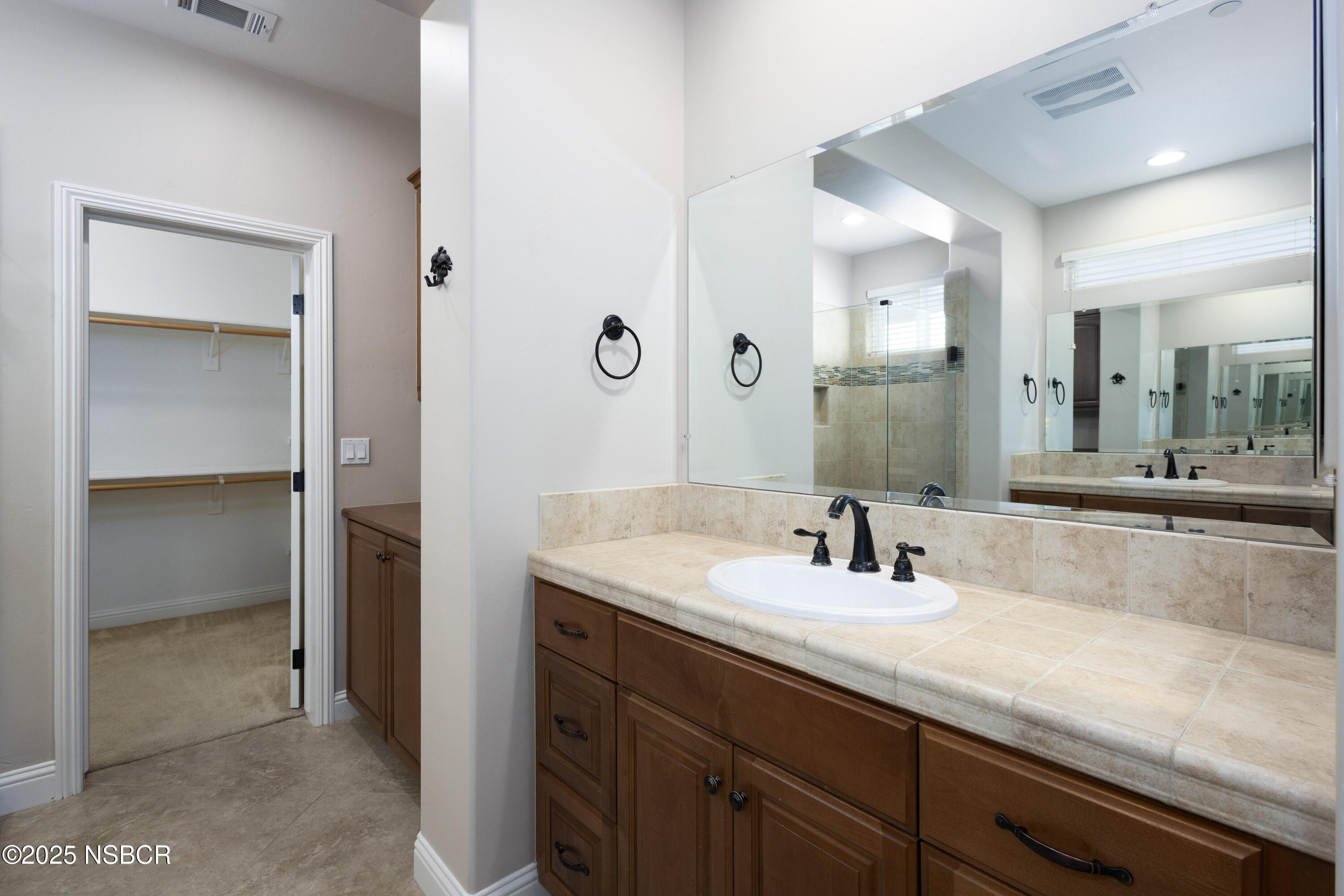 775 Mahogany Street Santa Maria, CA 93455 - Photo 17 of 34 a bathroom with a sink and a mirror