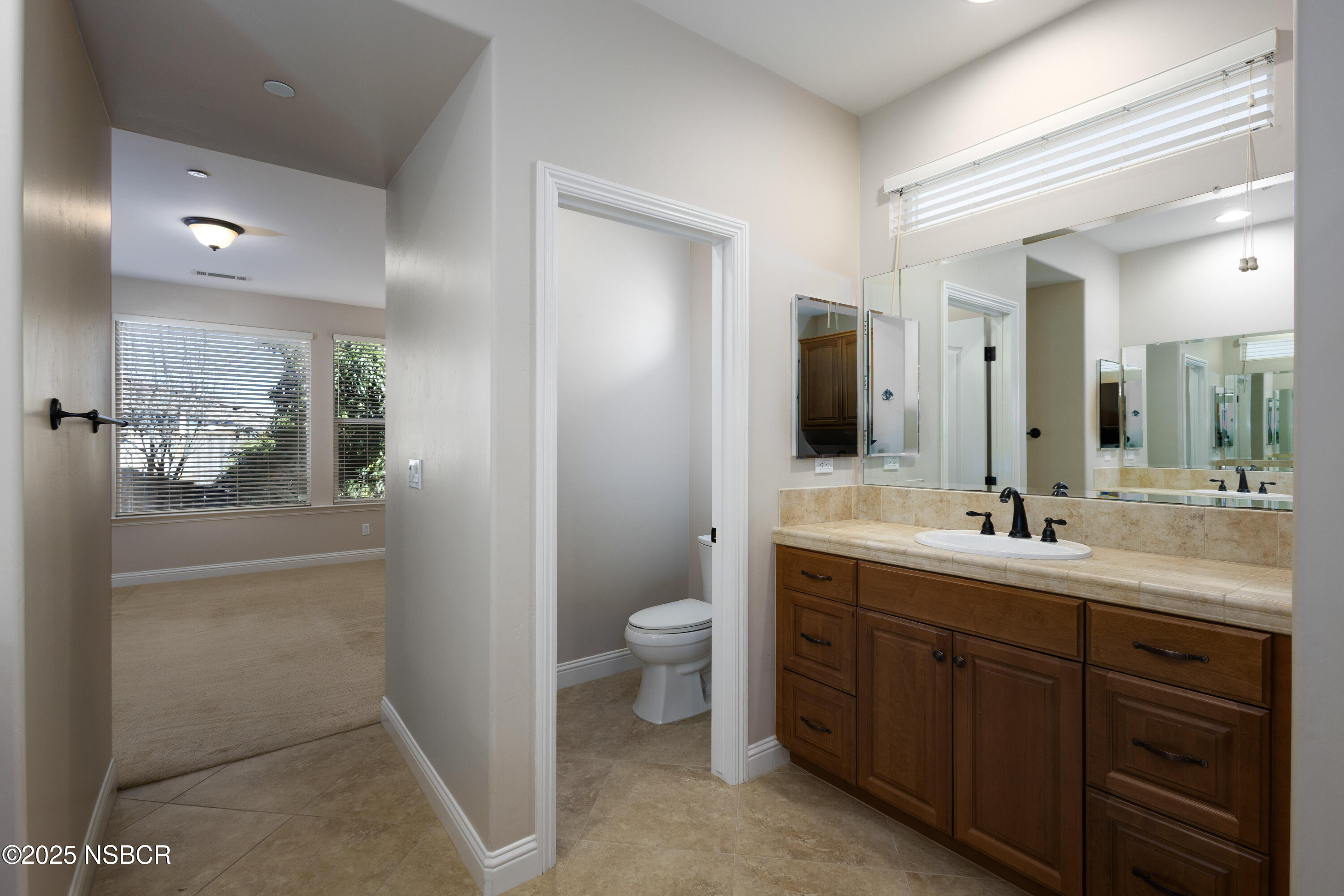 775 Mahogany Street Santa Maria, CA 93455 - Photo 19 of 34 a spacious bathroom with a double vanity sink toilet and a mirror